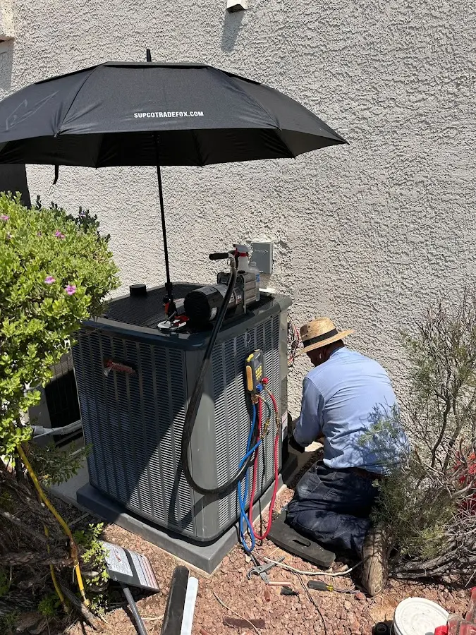 HVAC technician performing outdoor AC maintenance in Bluffdale